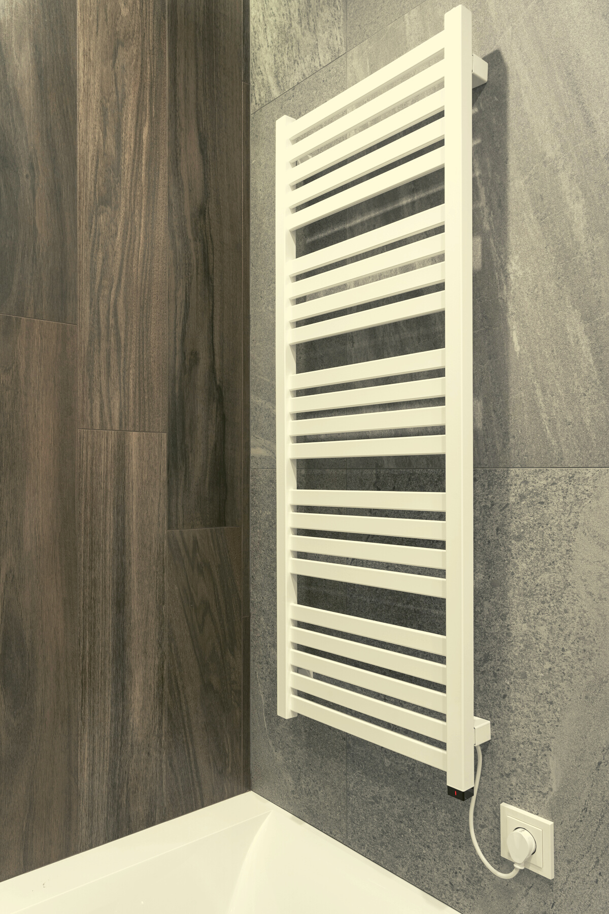 White and modern heated towel rail in bathroom